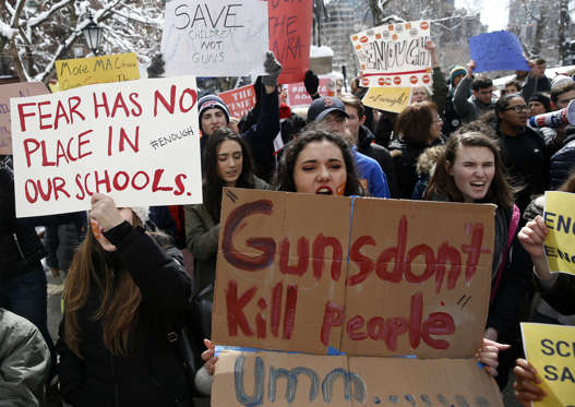 Slide 1 of 56: BOSTON, MA - MARCH 14: Nicole Rivera, 14, a Freshman at Arlington High School, center, rallies with other students in front of the Massachusetts State House in Boston to demand action on gun violence as part of a nationwide school walkout on March 14, 2018. (Photo by Jessica Rinaldi/The Boston Globe via Getty Images)