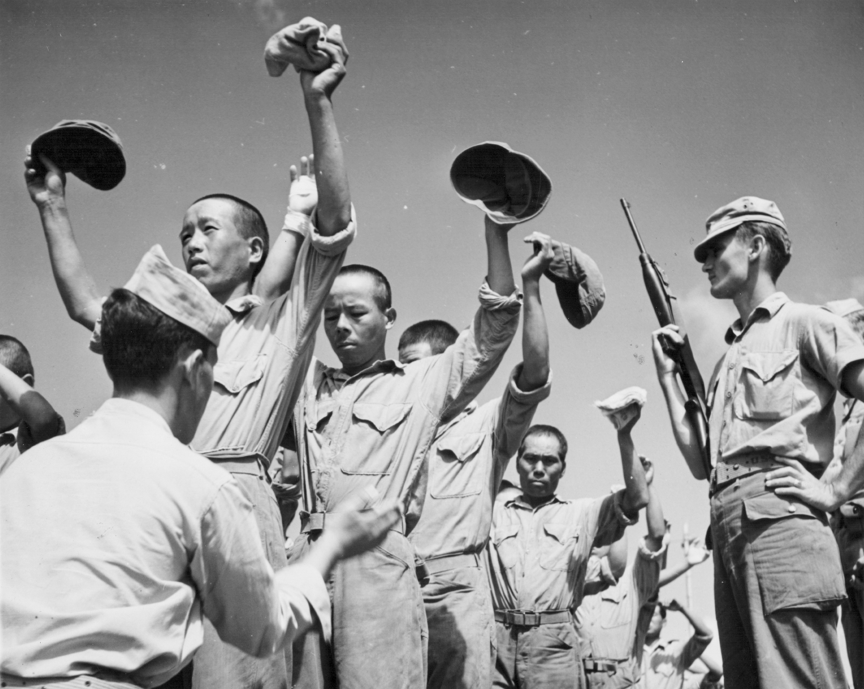 Slide 6 of 9: Japanese prisoners of war being checked by US marines following the allied victory in Guam, during the Pacific Campaign of World War Two, Guam, 1944. (Photo by US Navy/Getty Images)