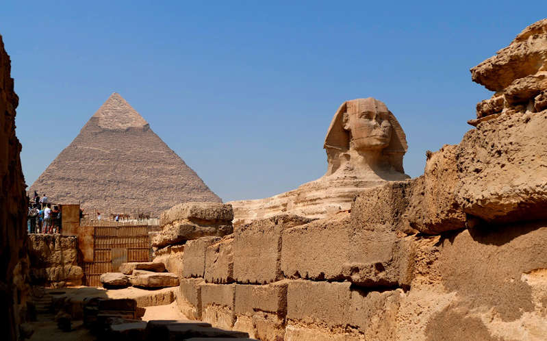 The Great Sphinx of Giza set against the Pyramid of Khufu