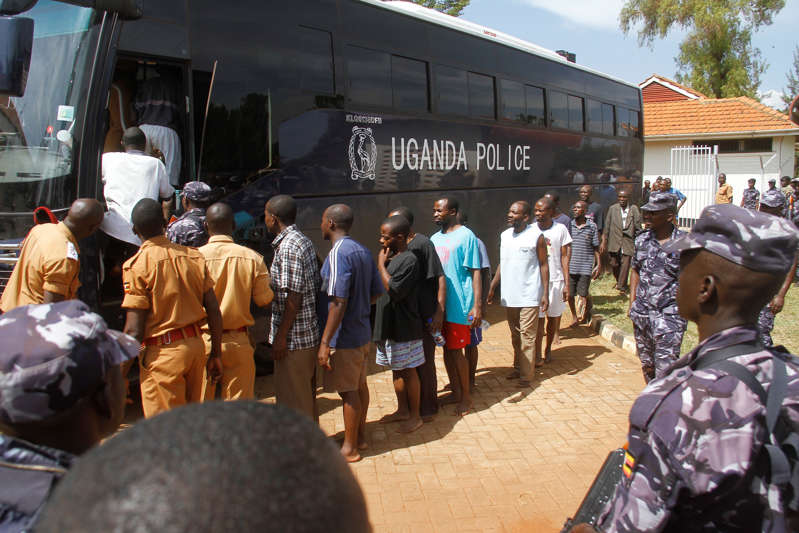 FILE: Defendants wait to be transferred after attending a trial session at the Jinja Magistrates court in Jinja, Uganda on December 14, 2016.
