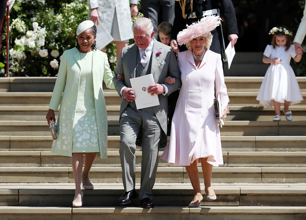 Doria Ragland, mother of the bride, Prince Charles, Prince of Wales and Camilla, Duchess of Cornwall walk down the steps at Windsor Castle after the wedding of Prince Harry and Meghan Markle