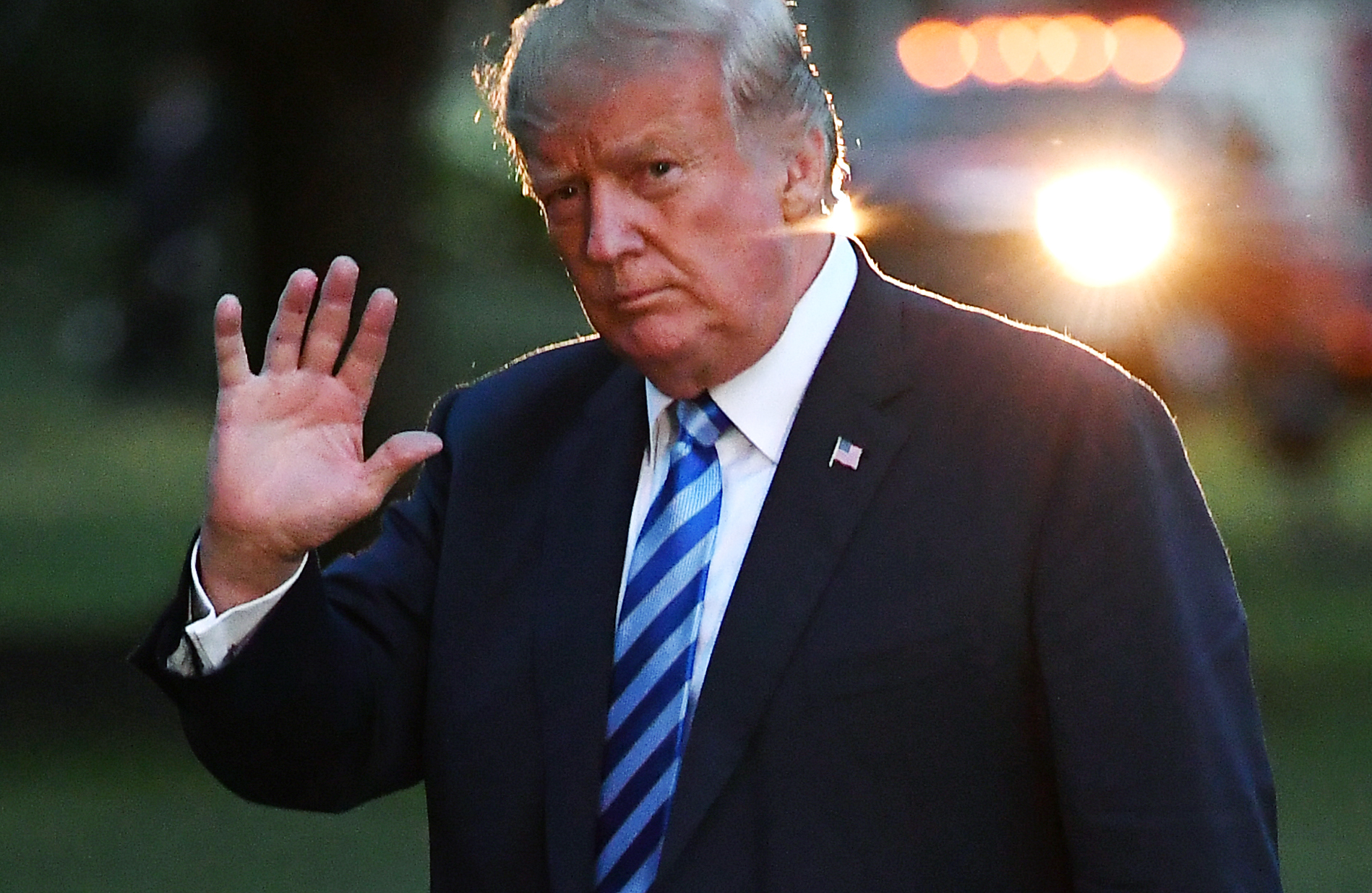 President Donald Trump waves as he makes his way across the South Lawn upon return to the White House in Washington, DC, on August 13, 2018.