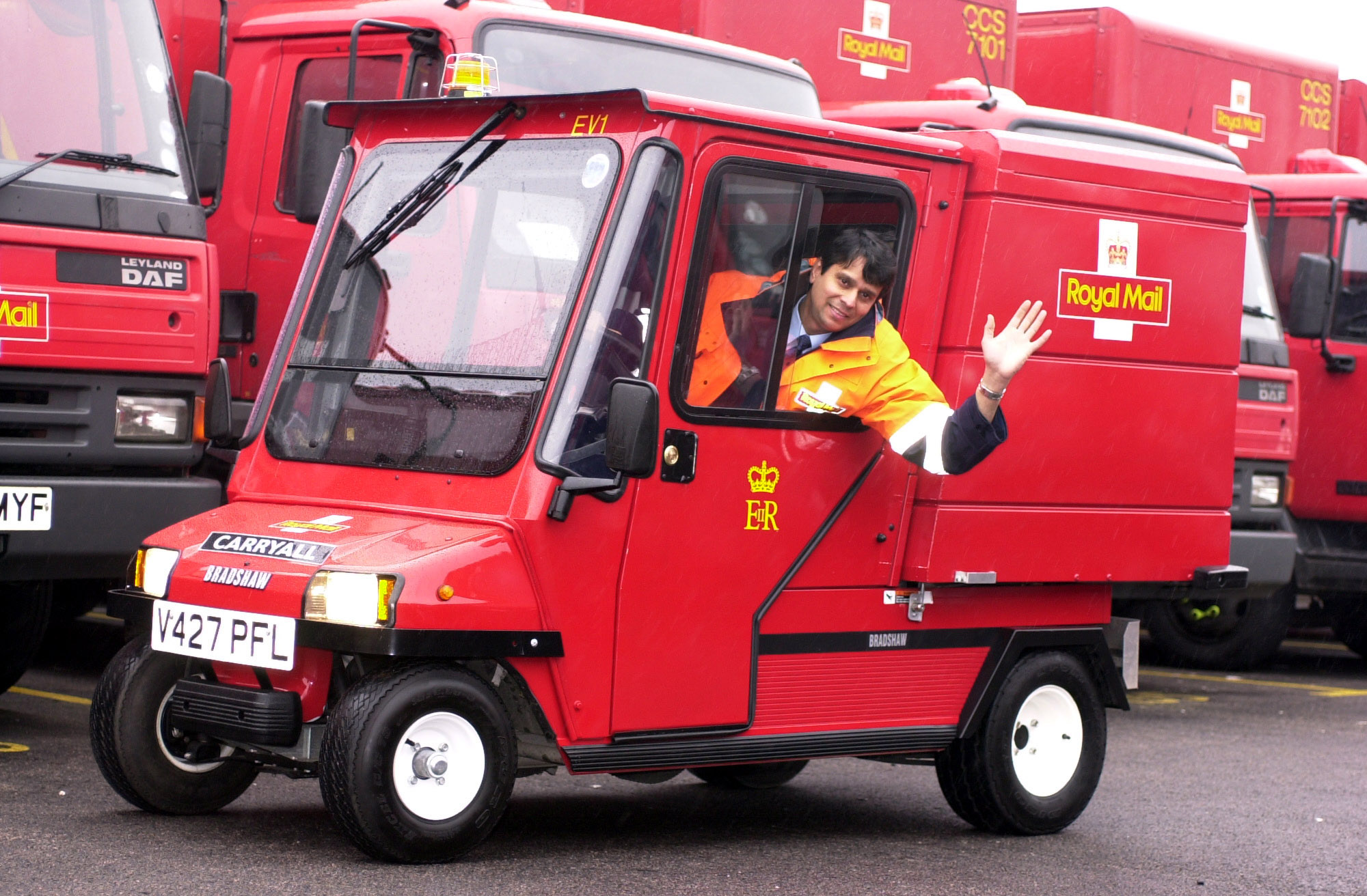 Nav Vyas, a postman from Oxford, demonstrates the Royal Mail's new electric mail cart for delivering post in busy city centres, in London. The  carryall has a top speed of 18 mph and can carry loads of more than 250 kilos, and is charged up over night.   * The cart, which looks remarkably like a grown up version of Postman Pat's famous red van.   (Photo by Fiona Hanson - PA Images/PA Images via Getty Images)