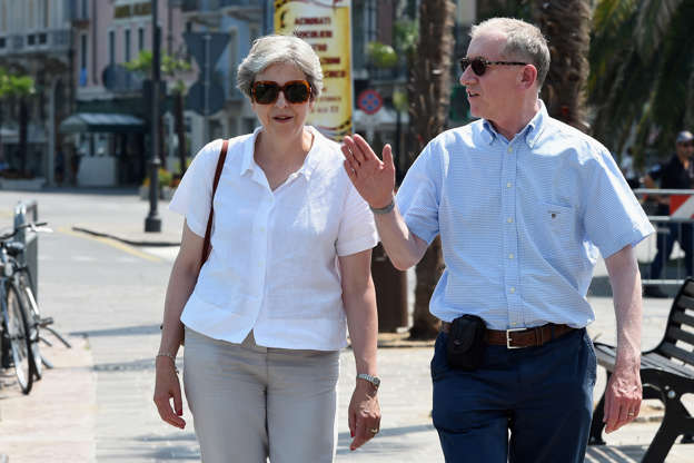 Britain's Prime Minister Theresa May and her husband Philip walk on the waterfront whilst on vacation in Desenzano del Garda, Italy, July 29, 2018. Pier Marco Tacca/Pool via REUTERS