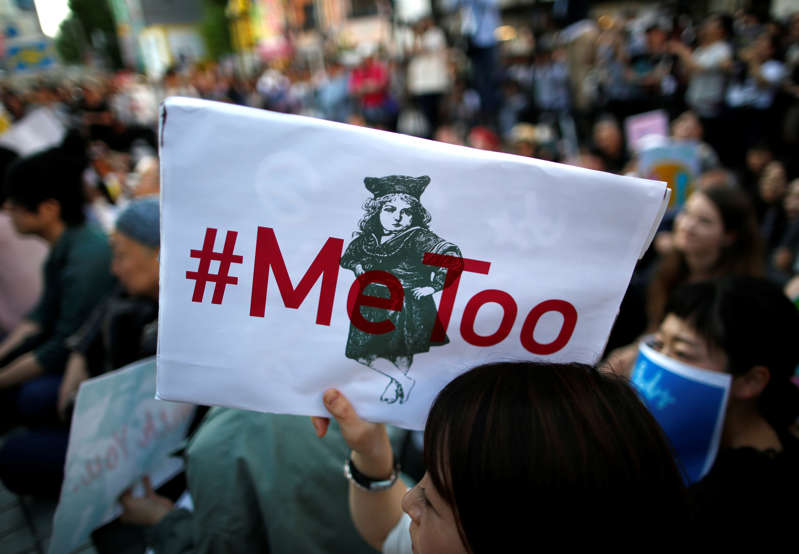 A protester raises a placard reading "#MeToo" during a rally against harassment at Shinjuku shopping and amusement district in Tokyo, Japan, April 28, 2018. Picture taken April 28, 2018.   REUTERS/Issei Kato