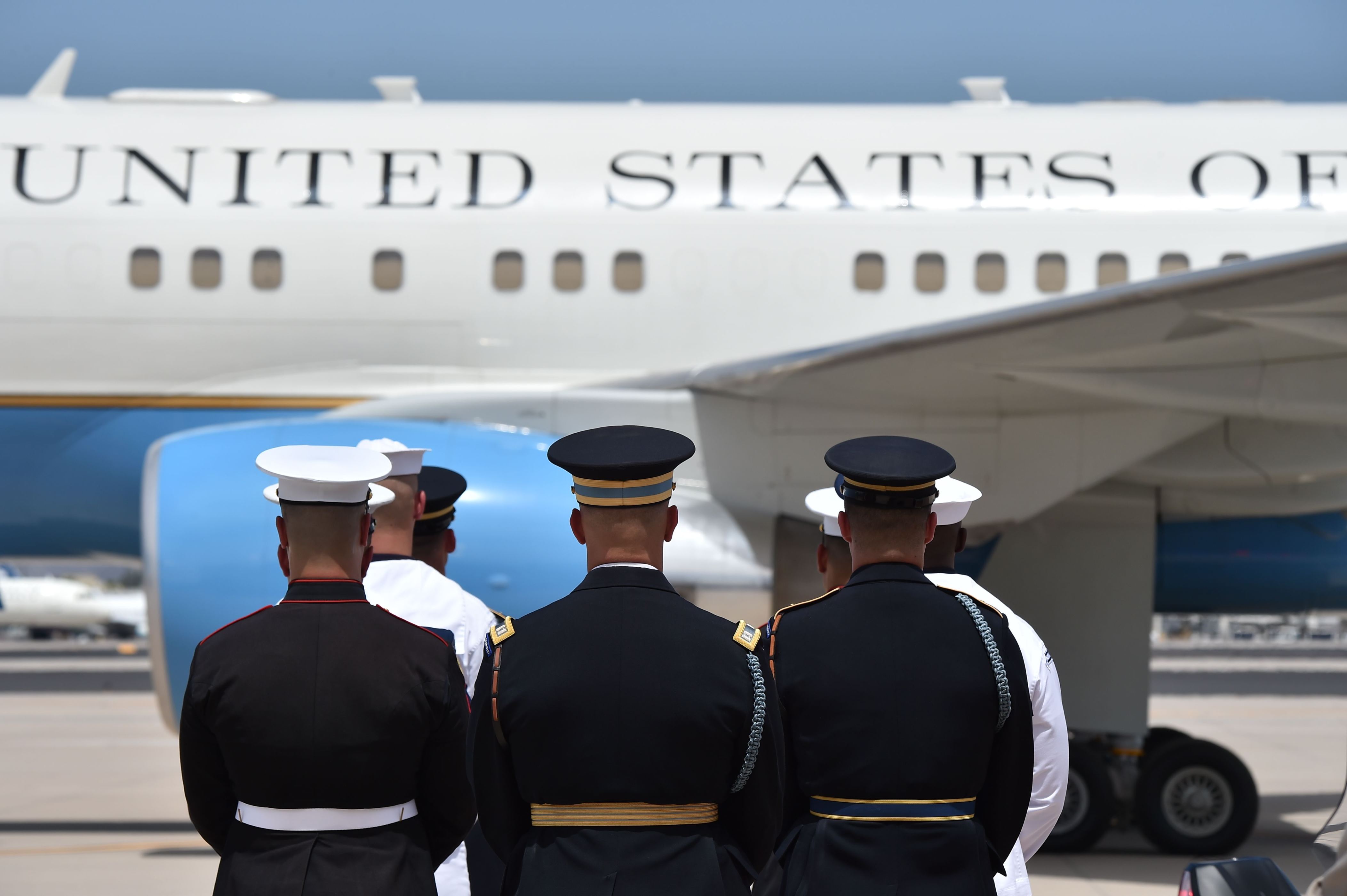 Slide 3 of 42: Members of the US military stand as casket of US Sen. John McCain is carried to a plane, after his memorial service at the North Phoenix Baptist Church, August 30, 2018 in Phoenix, Arizona en route to Washington,DC. (Photo by Robyn Beck / AFP)        (Photo credit should read ROBYN BECK/AFP/Getty Images)