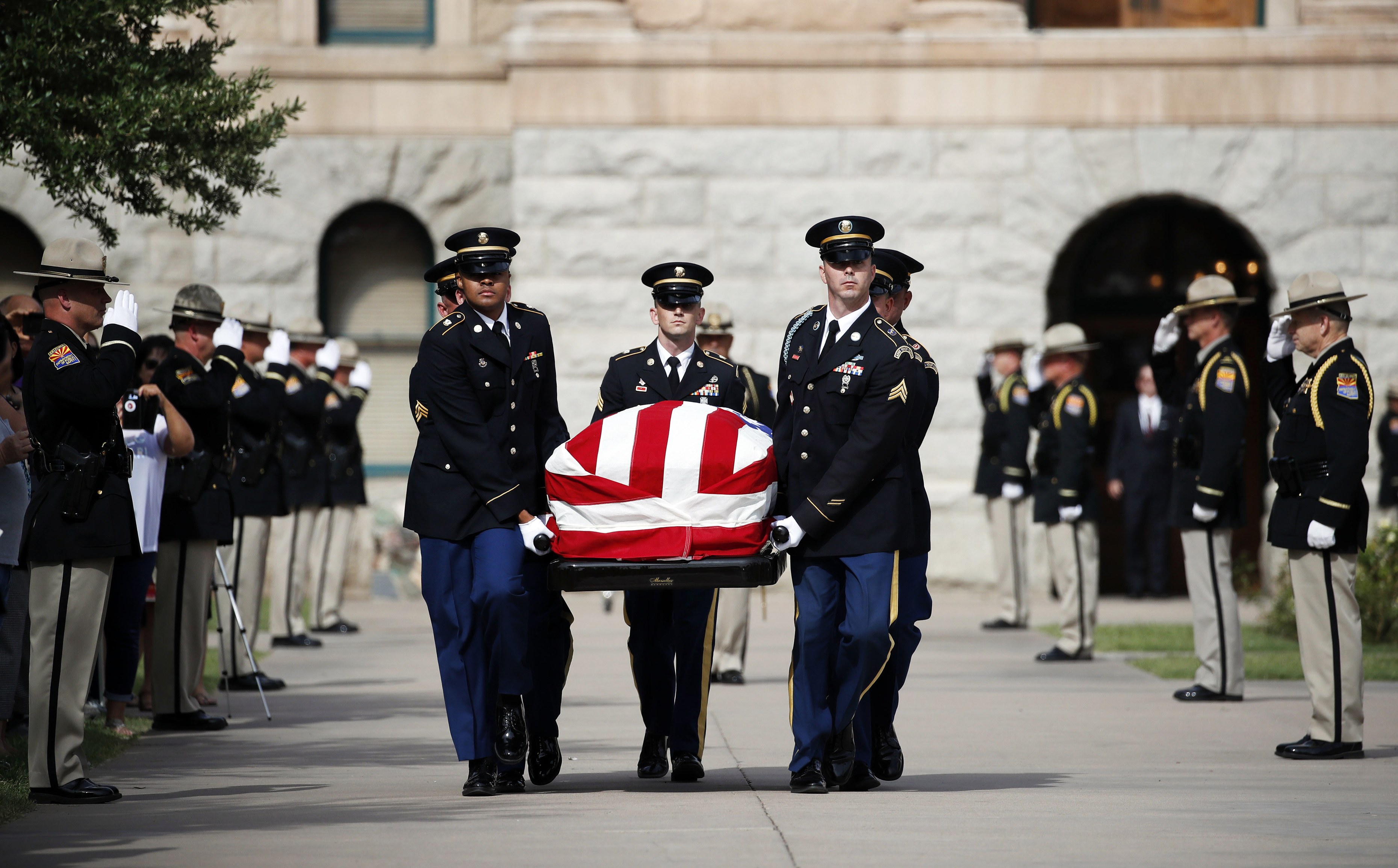 Slide 1 of 42: The Arizona National Guard carries the casket of Sen. John McCain, R-Ariz. from the Arizona Capitol as it heads to the North Phoenix Baptist Church for a memorial service on Thursday, Aug. 30, 2018, in Phoenix.