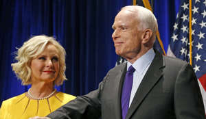 FILE - In this Nov. 8, 2016 file photo, Sen. John McCain, R-Ariz., accompanied by his wife Cindy McCain, pauses after speaking in Phoenix. A Trump administration official says that Cindy McCain is likely to take on a prominent State Department role. (AP Photo/Ross D. Franklin, File)