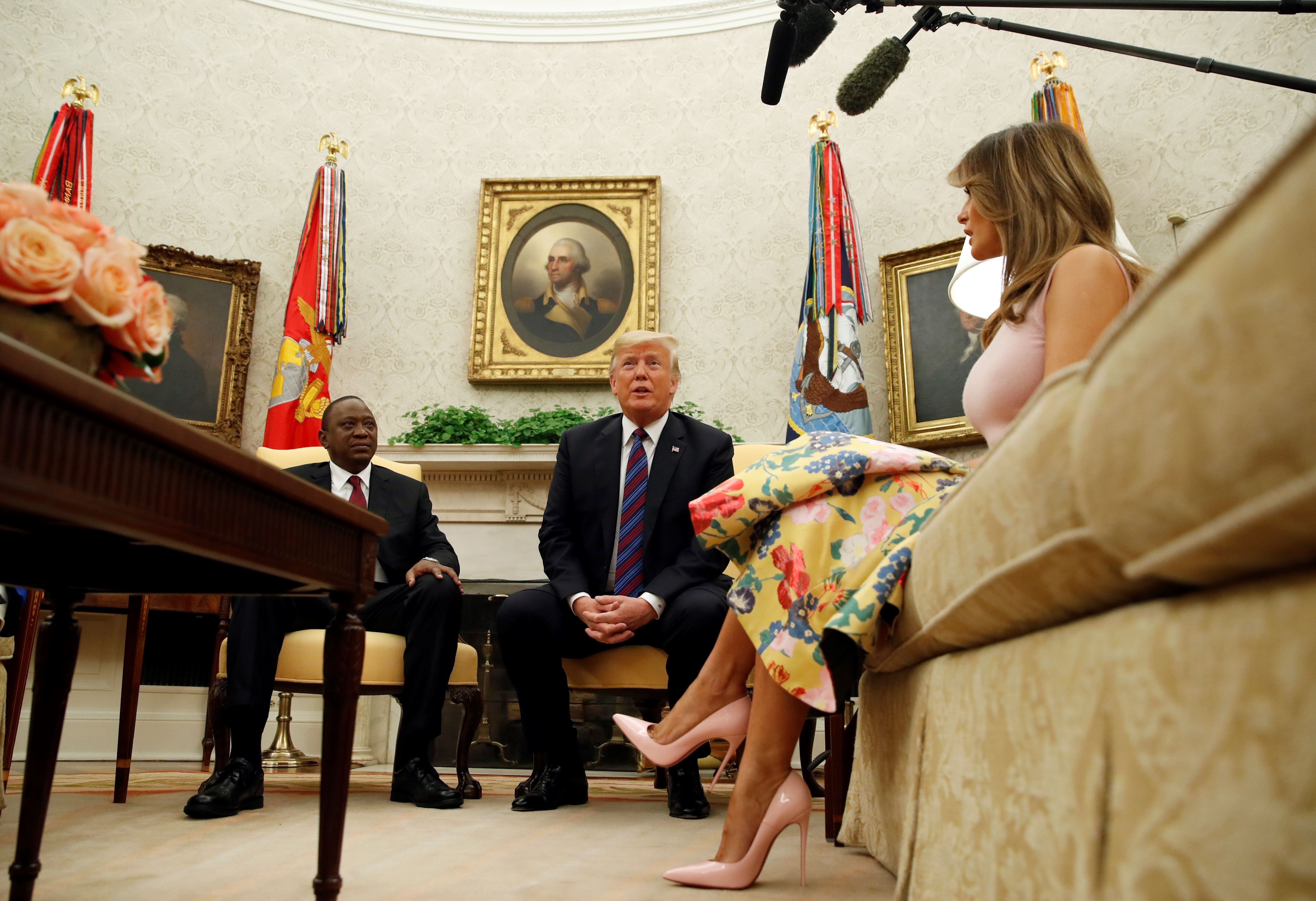 President Donald Trump speaks with Kenyan President Uhuru Kenyatta, accompanied by first lady Melania Trump, right, in the Oval Office of the White House, Monday, Aug. 27, 2018, in Washington. (AP Photo/Alex Brandon)