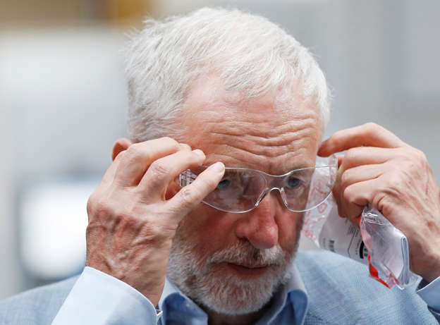 Jeremy Corbyn, the leader of Britain's Labour Party, dons protective eyewear as he visits DePe Gear in Stoke-on-Trent, August 14, 2018. REUTERS/Darren Staples
