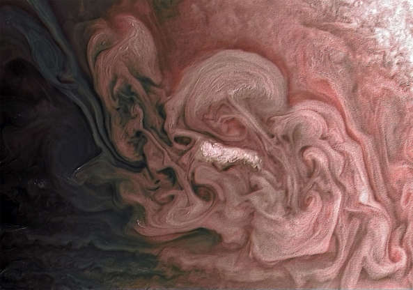 Slide 1 de 25: This image captures a close-up view of a storm with bright cloud tops in the northern hemisphere of Jupiter.