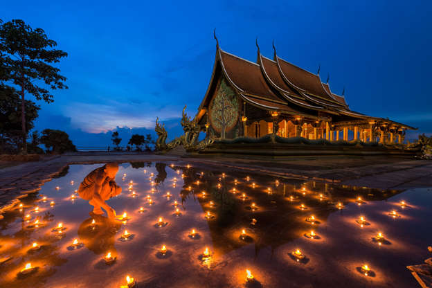 The light up of faith - Kiatanan Sugsompian/Getty Images Slide 16 de 24: The buddhist novice was light candles in Sirindhorn Wararam Phu Prao temple, Ubon Ratchathani, Thailand. Highlights of the temple is the beautiful images of the fluorescent green of Kanlapaphruek tree, a painting on the back wall of the temple in the evening.