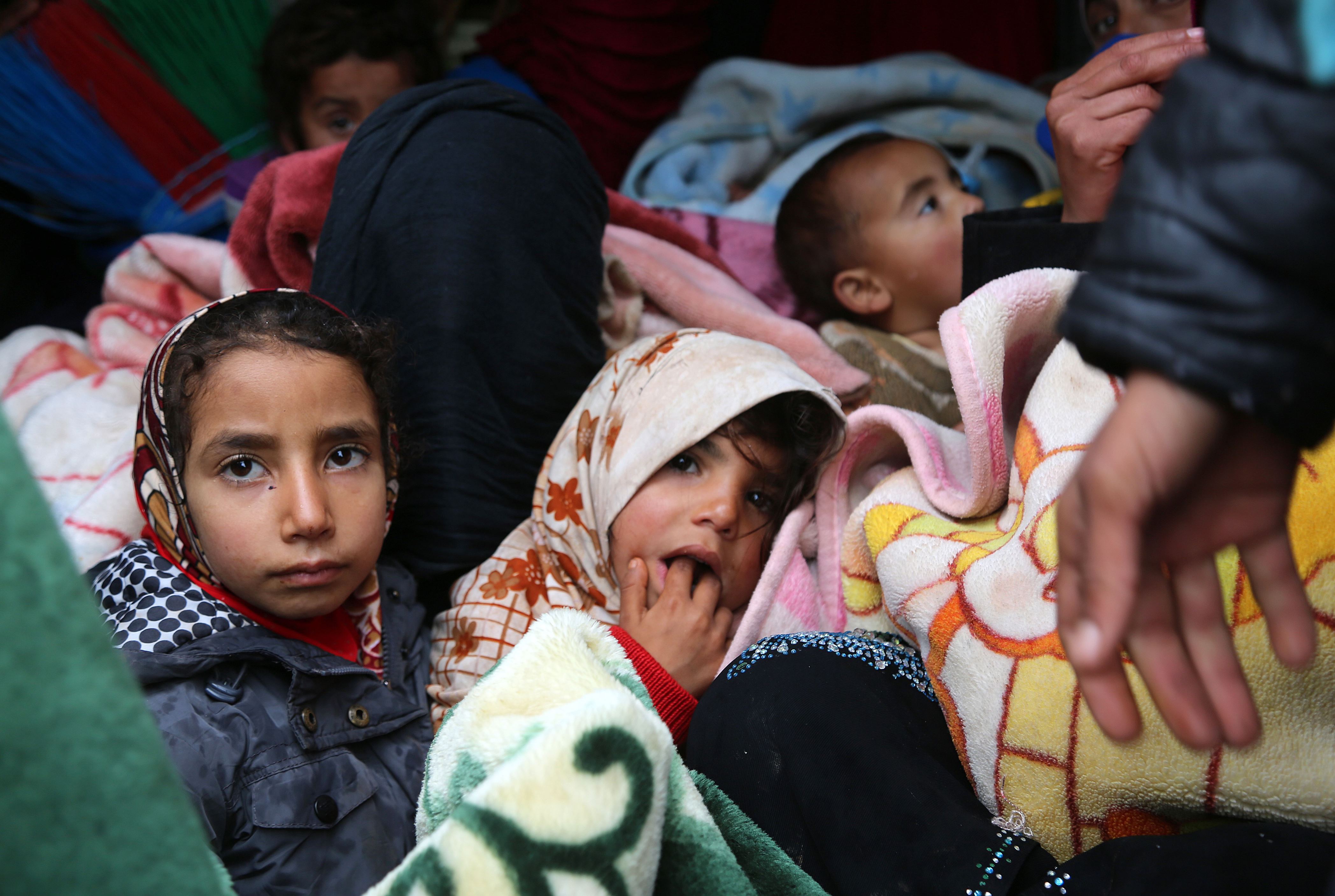 Syrians who fled from the outskirts of southern Idlib due to conflict between government forces and opposition fighters take shelter following their arrival at the make-shift camp of Kalbeed near the Bab al-Hawa crossing on the Syria-Turkey border on January 4, 2018.  Government and allied forces backed by Russian warplanes have been battling jihadist fighters and rebels for over a week in an area straddling the border between Idlib and Hama provinces. / AFP PHOTO / Zein Al RIFAI        (Photo credit should read ZEIN AL RIFAI/AFP/Getty Images)