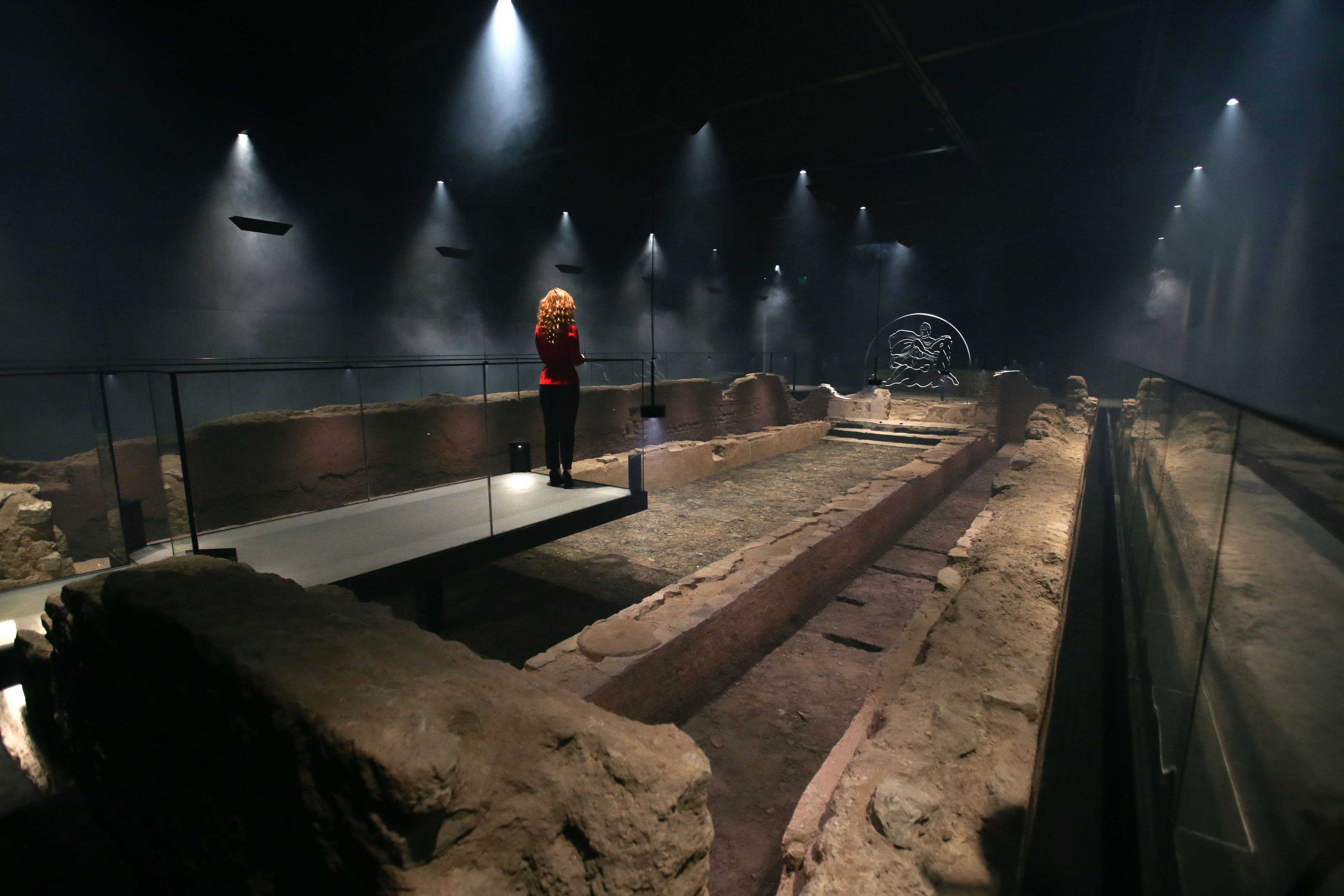 Slide 28 of 77: An employee poses alongside a reconstruction of the Roman Temple of Mithras, recreated on the site of its original discovery, during a press preview at the London Mithraeum, Bloomberg SPACE, at the new Bloomberg headquarters in central London, on November 7, 2017.
The third century reconstructed temple, sits seven meters below the City of London. / AFP PHOTO / Daniel LEAL-OLIVAS        (Photo credit should read DANIEL LEAL-OLIVAS/AFP/Getty Images)