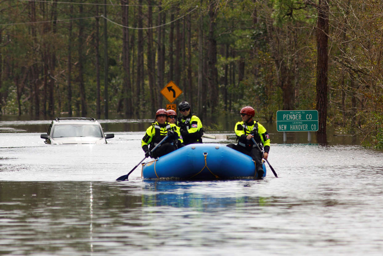 Slide 2 of 86: A search and rescue task force patrols a flooded region by boat over a fully submerged road in the aftermath of Hurricane Florence in Castle Hayne, North Carolina, U.S., September 17, 2018.