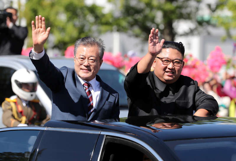 South Korean President Moon Jae-in and North Korean leader Kim Jong Un wave during a car parade in Pyongyang, North Korea, September 18, 2018. Pyeongyang Press Corps/Pool via REUTERS