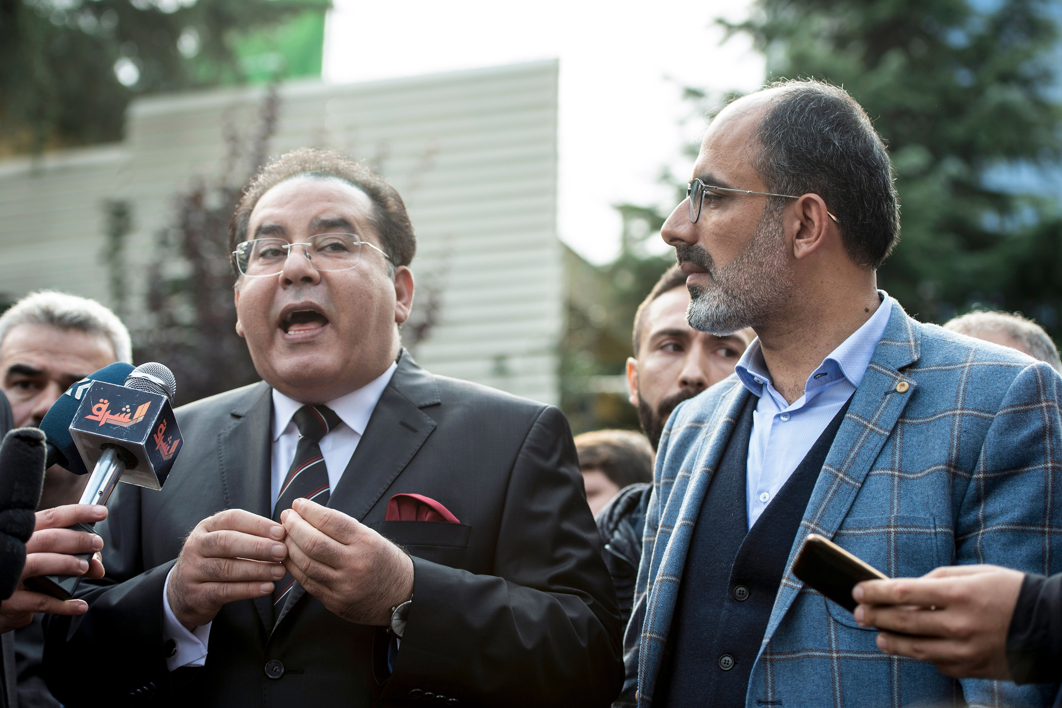 Slide 2 of 64: Egyptian opposition politician Ayman Nour (L), flanked by Turkish journalist Turan Kislakci (R), head of the Turkish-Arab Media Association, address media in front of the Saudi consulate in Istanbul, on October 20, 2018. - Saudi Arabia admitted on October 20, 2018 that critic Jamal Khashoggi was killed inside its Istanbul consulate, saying he died during a "brawl", as Turkey vowed to release the full findings of its own investigation. (Photo by Yasin AKGUL / AFP)        (Photo credit should read YASIN AKGUL/AFP/Getty Images)
