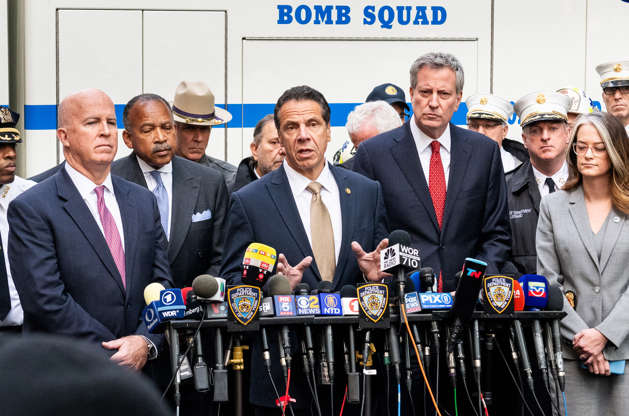 Slide 1 of 21: New York City Police Commissioner James O'Neill (on the left), New York State Governor Andrew Cuomo (center, speaking), and New York City Mayor Bill de Blasio (on the right) seen speaking about the bomb threat at CNN's New York City headquarters in the Time Warner Building at the Columbus Circle in New York City.