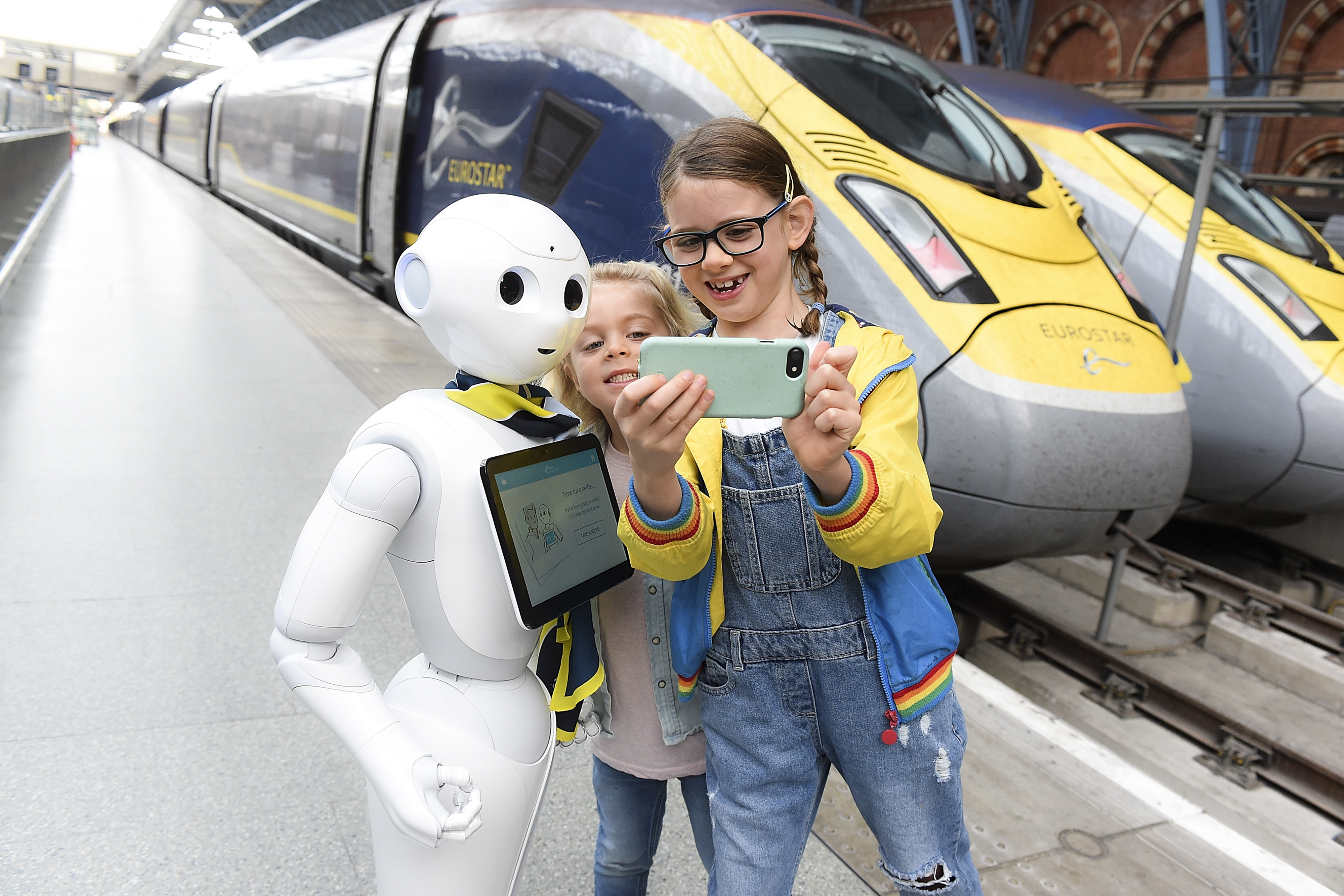 Slide 32 of 39: Pepper the robot meets Eurostar customers at St Pancras International station in London, England. Pepper will be available to entertain customers, offering information about their journey before departure on Oct. 23.
