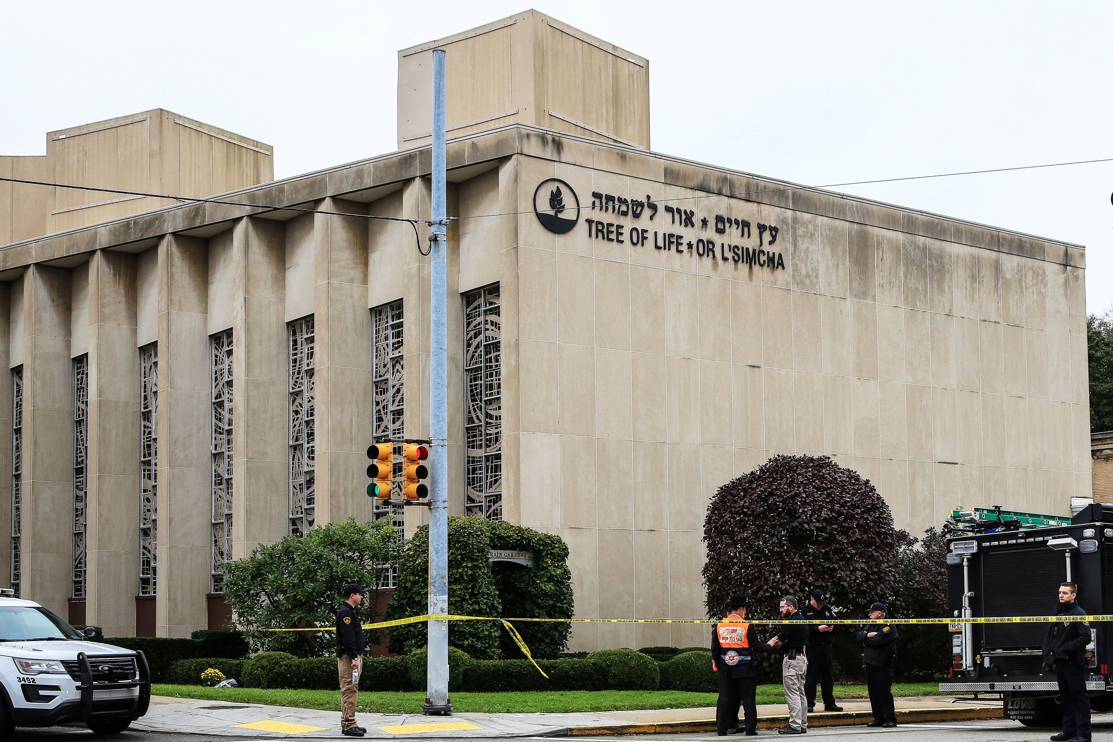 Slide 6 of 21: Police officers guard the Tree of Life synagogue following shooting at the synagogue in Pittsburgh, Pennsylvania, U.S., October 27, 2018.