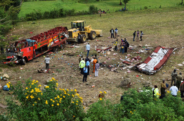 Kenya accident - Brian Ongoro/AFP/Getty Images Kenyan emergency personnel and security forces inspect the wreckage of a bus at the site of an accident in Kericho, western Kenya, on Oct. 10, 2018.