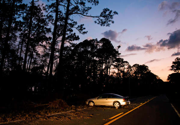 Slide 2 of 77: A car damaged during Hurricane Michael blocks part of highway 98 near Lanark Village, Florida on October 11, 2018. - The death toll from Hurricane Michael, which slammed into the Florida coast as a Category 4 storm, has risen to at least six in three states, US officials said on Thursday, October 11, 2018. (Photo by ANDREW CABALLERO-REYNOLDS / AFP)        (Photo credit should read ANDREW CABALLERO-REYNOLDS/AFP/Getty Images)