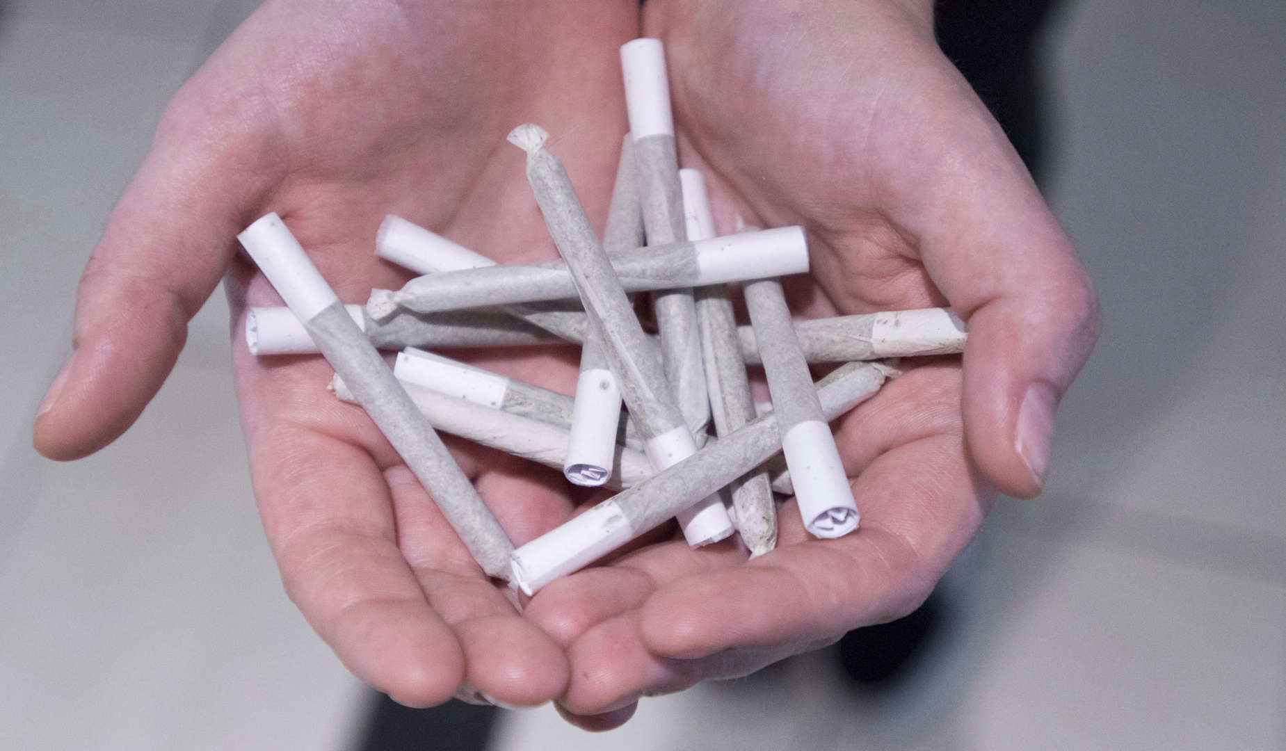 A employee holds pre-rolled joints at Buddha Barn Craft Cannabis in Vancouver, Tuesday, Oct. 2, 2018... - THE CANADIAN PRESS/Jonathan Hayward Slide 30 of 31: A employee holds pre-rolled joints at Buddha Barn Craft Cannabis in Vancouver, Tuesday, Oct. 2, 2018.