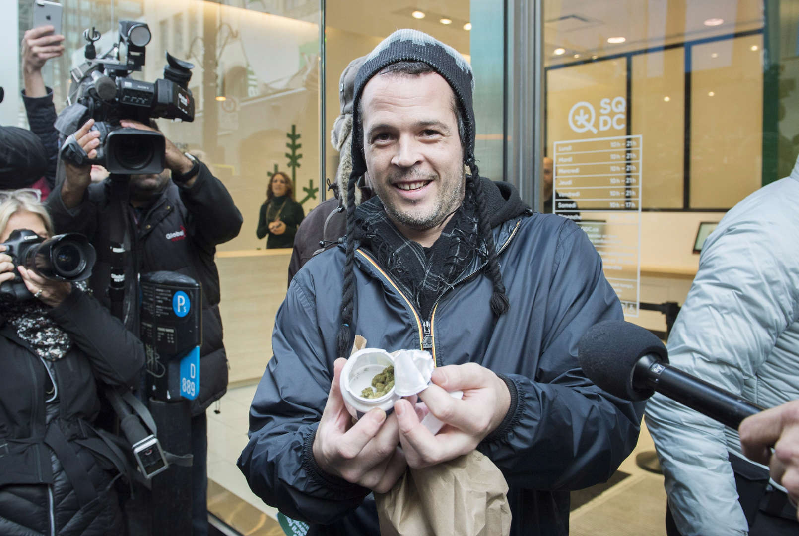 A man displays his legal cannabis products after buying them from a government cannabis store in Mon... - THE CANADIAN PRESS/Graham Hughes Slide 16 of 31: A man displays his legal cannabis products after buying them from a government cannabis store in Montreal, Wednesday, October 17, 2018.