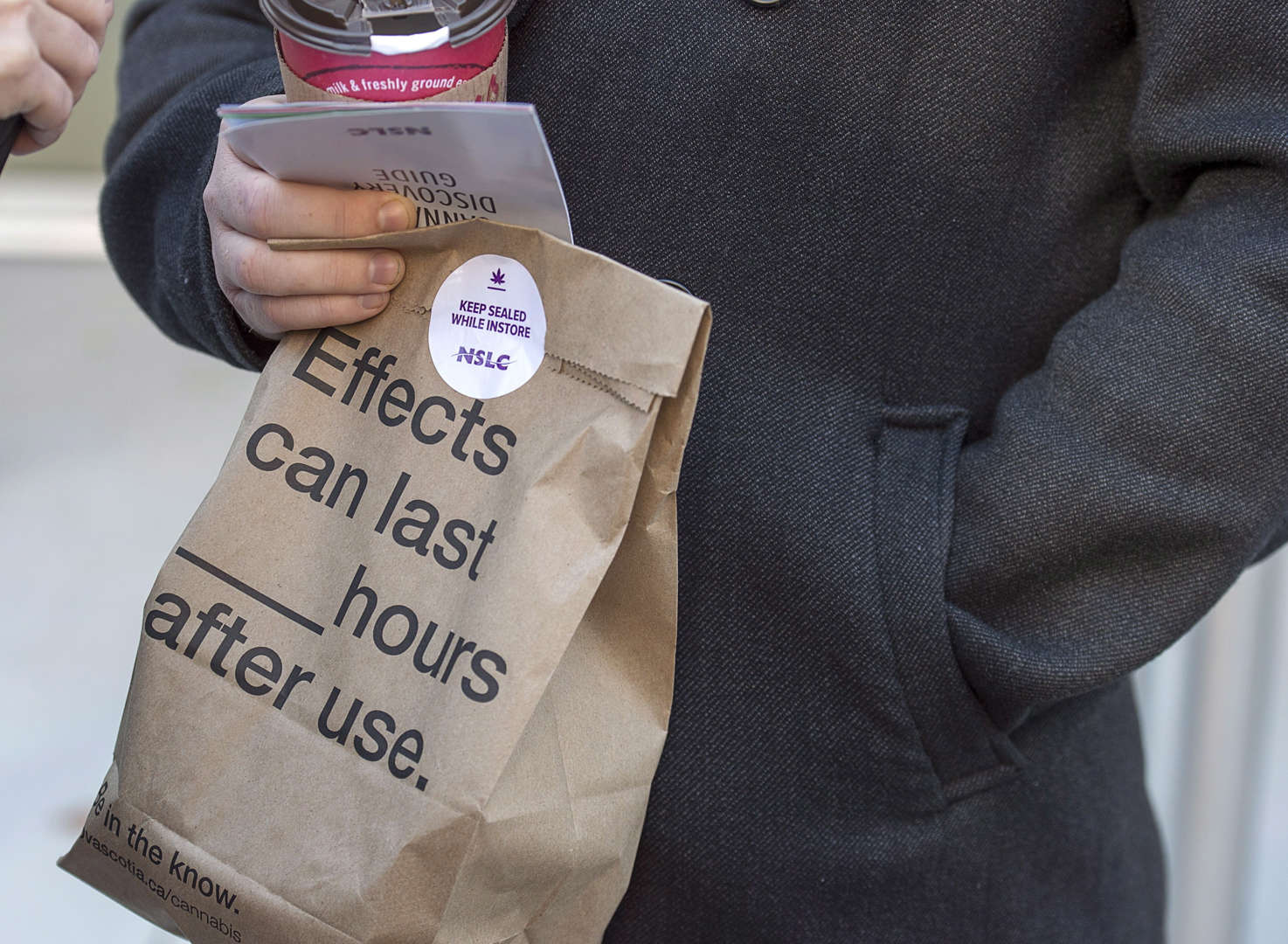 A customer carries his purchase after leaving the Nova Scotia Liquor Corporation cannabis store in H... - THE CANADIAN PRESS/Andrew Vaughan Slide 2 of 31: A customer carries his purchase after leaving the Nova Scotia Liquor Corporation cannabis store in Halifax on Oct. 17, 2018.