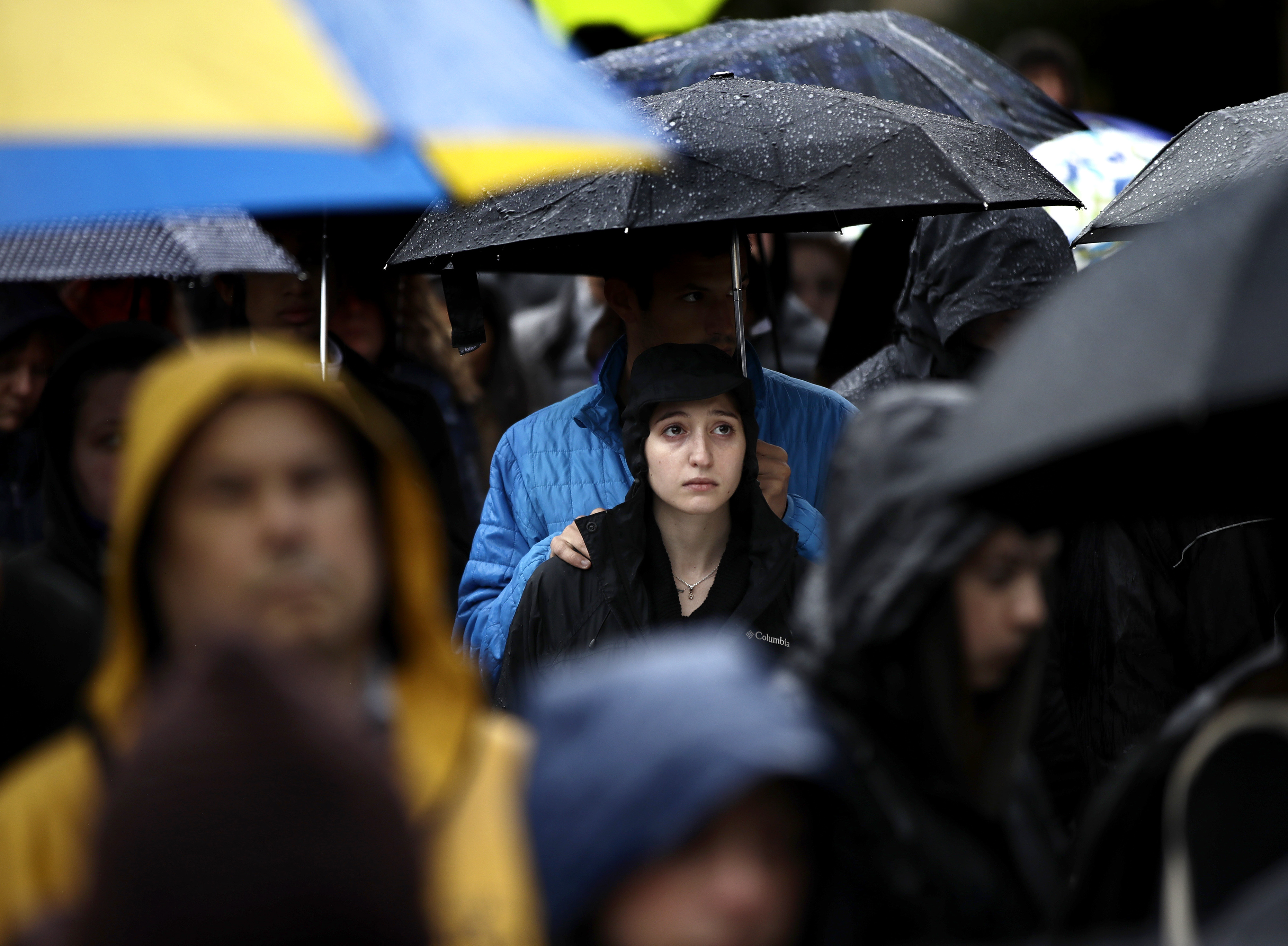 Slide 4 of 49: People stand outside the Soldiers & Sailors Memorial Hall & Museum due to over-capacity and listen via speakers to a community gathering inside, Sunday, Oct. 28, 2018, in Pittsburgh, in the aftermath of the deadly shooting at the Tree of Life Synagogue a day earlier.
