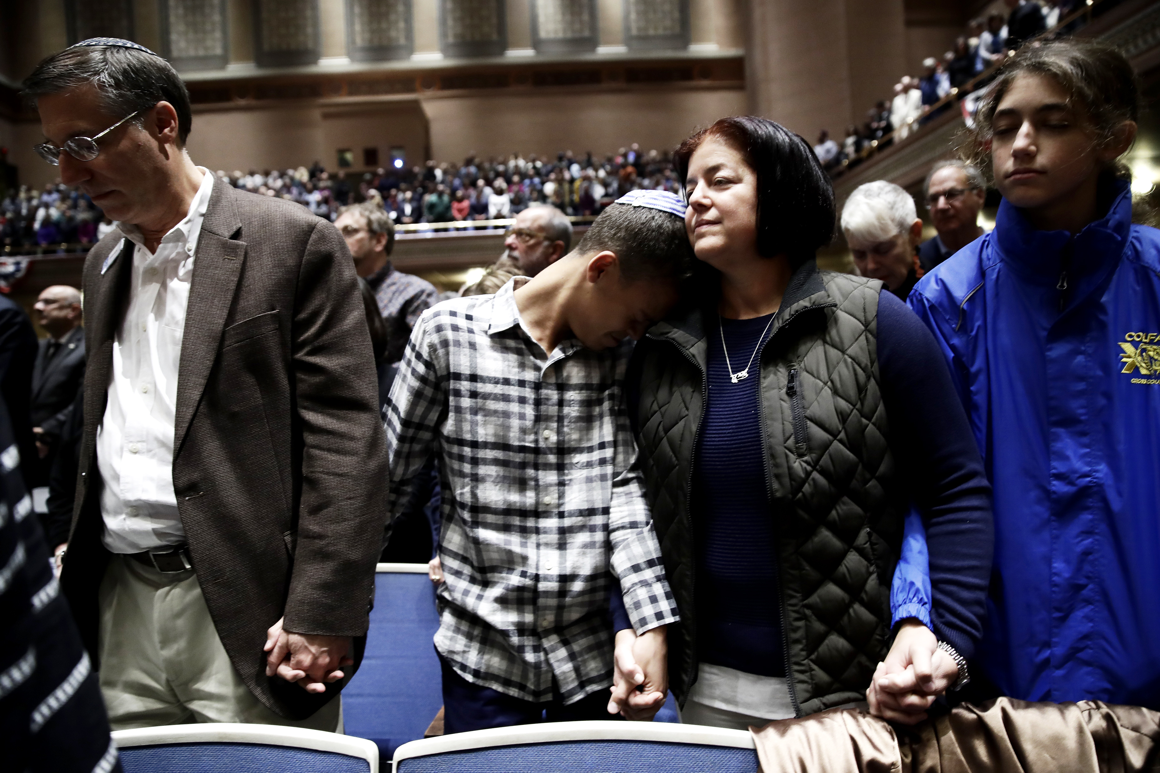 Slide 2 of 49: People mourn in Soldiers & Sailors Memorial Hall & Museum during a community gathering held in the aftermath of Saturday's deadly shooting at the Tree of Life Synagogue in Pittsburgh, Sunday, Oct. 28, 2018.