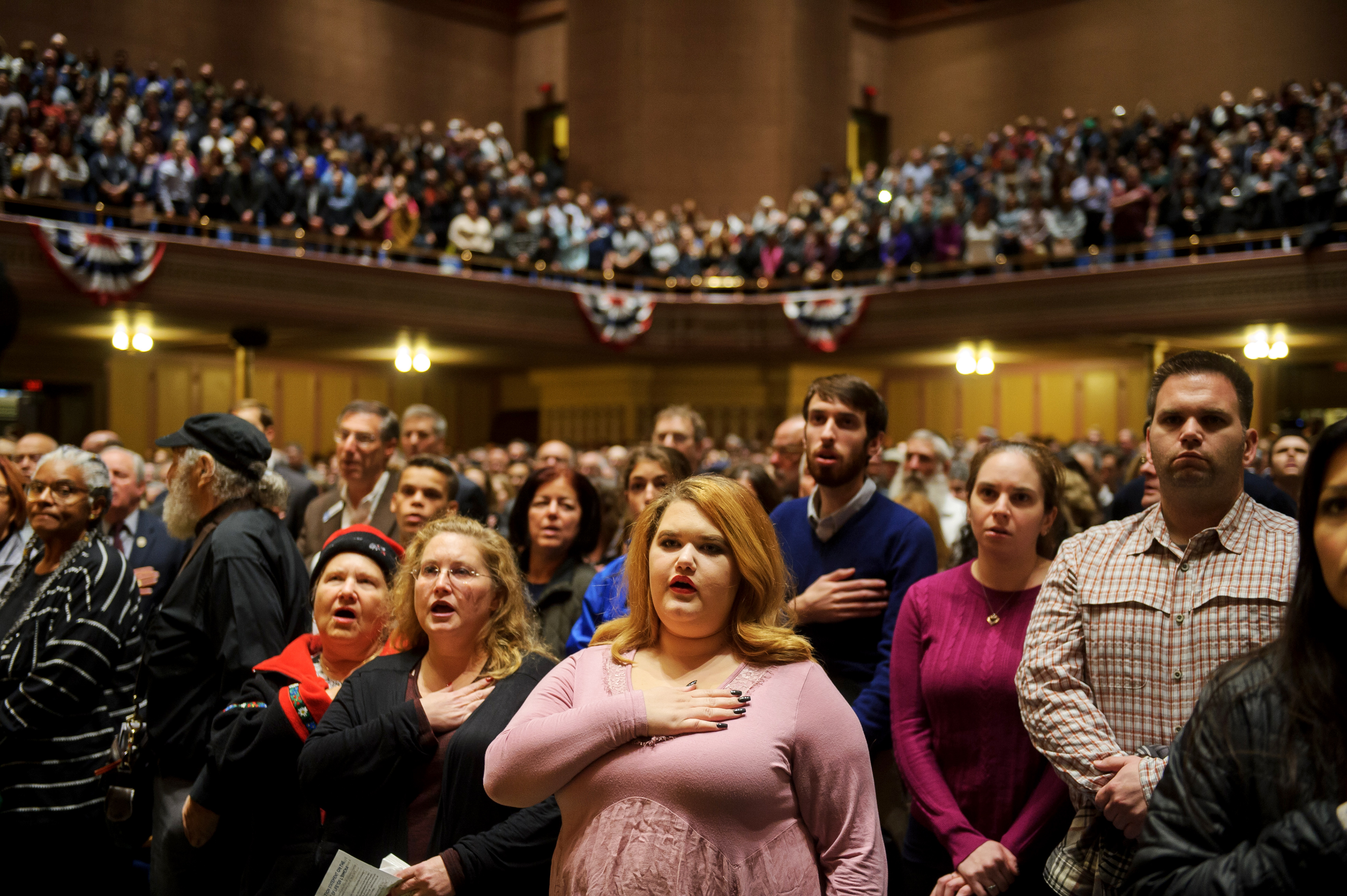 Slide 1 of 49: People listen to interfaith speakers at the Soldiers and Sailors Memorial Hall during a service to honor and mourn the victims of Saturday's mass shooting at the Tree Of Life Synagogue on October 28, 2018 in Pittsburgh, Pennsylvania.