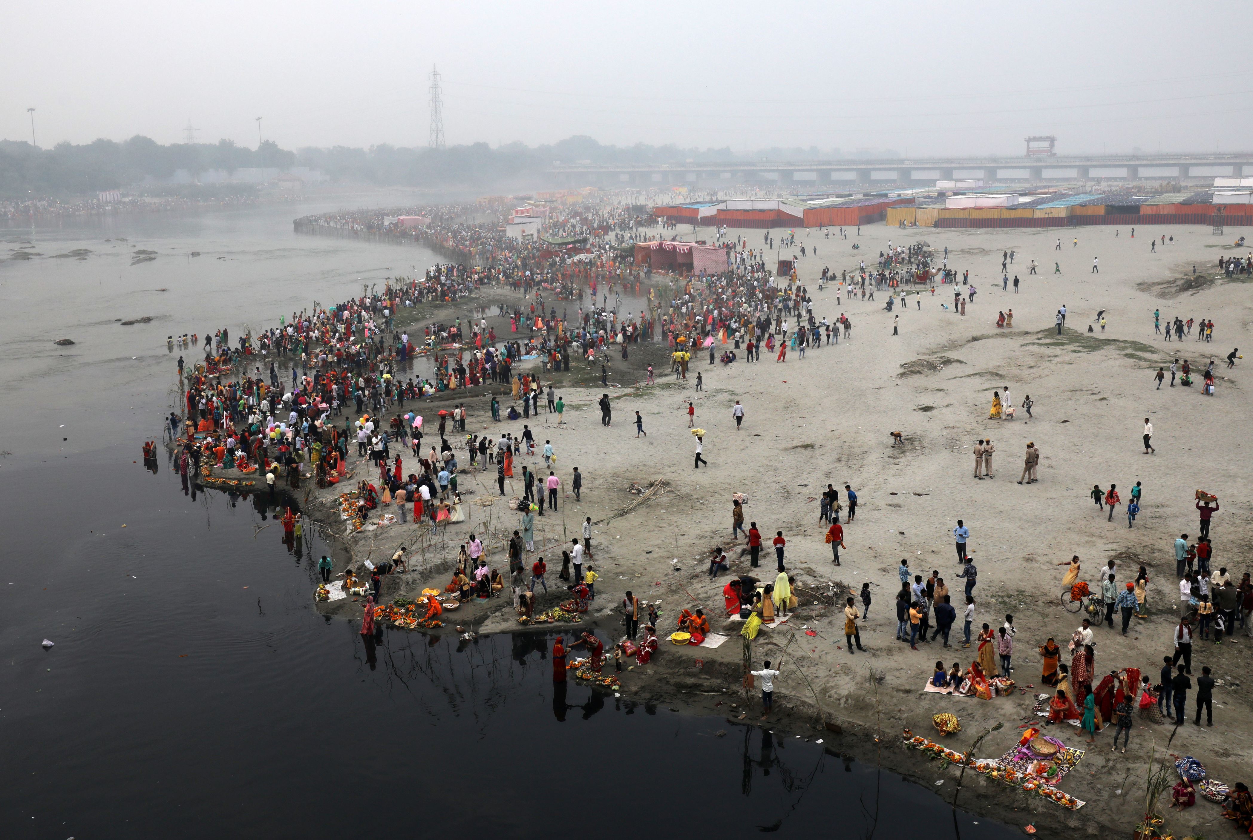 Women perform Chhath Puja at Yamuna river bank