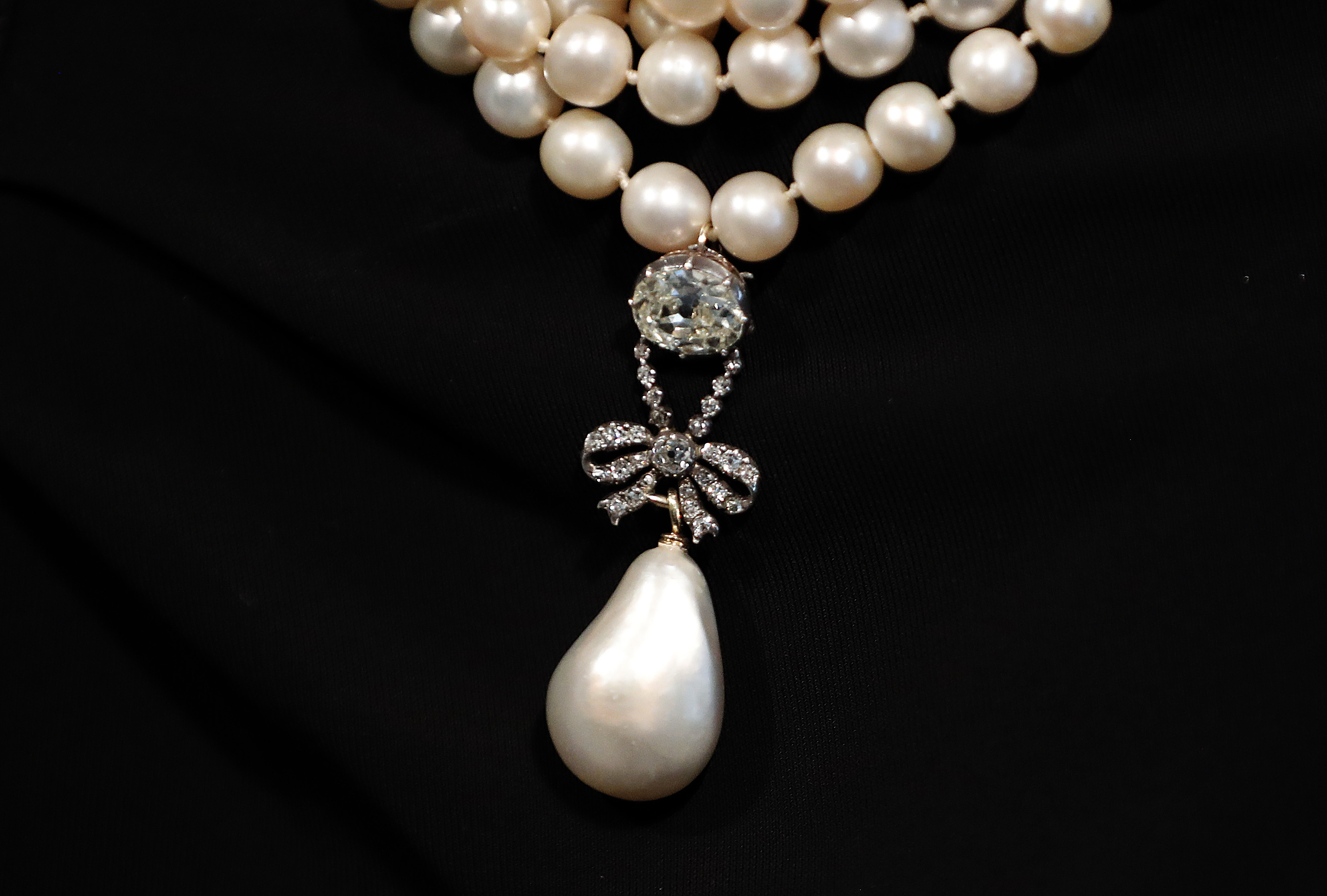 17 এর স্লাইড 1: Queen Marie Antoinette's Pearl displayed at Sotheby's in London, Friday, Oct. 19, 2018. The Pearl is estimated to fetch 1 million to 2 million USD. Jewels once owned by the last Queen of France Marie Antoinette will be going up for auction this autumn. And before the auction, the collection is making stops on an international tour where members of the public can view and even try on the royal pieces. (AP Photo/Frank Augstein)
