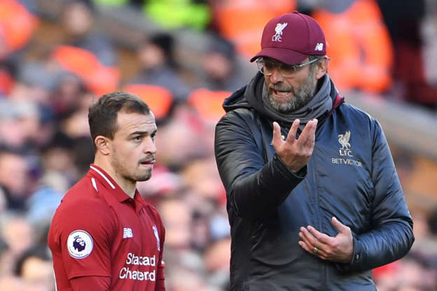 Liverpool's German manager Jurgen Klopp (R) talks with Liverpool's Swiss midfielder Xherdan Shaqiri (L) on the touchline during the English Premier League football match between Liverpool and Cardiff City at Anfield in Liverpool, north west England on October 27, 2018. (Photo by Paul ELLIS / AFP) / RESTRICTED TO EDITORIAL USE. No use with unauthorized audio, video, data, fixture lists, club/league logos or 'live' services. Online in-match use limited to 120 images. An additional 40 images may be used in extra time. No video emulation. Social media in-match use limited to 120 images. An additional 40 images may be used in extra time. No use in betting publications, games or single club/league/player publications. /         (Photo credit should read PAUL ELLIS/AFP/Getty Images)