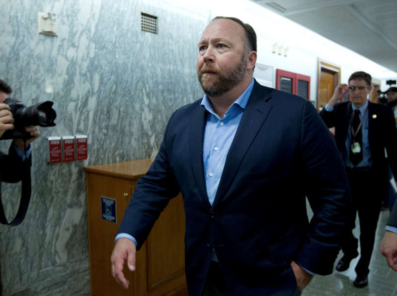 FILE - In this Wednesday, Sept. 5, 2018, file photo, Alex Jones, the right-wing conspiracy theorist, walks the corridors of Capitol Hill after listening to testimony on Capitol Hill in Washington. On Tuesday, Oct. 23, 2018, Twitter confirmed it has removed accounts linked to conspiracy-monger Alex Jones and Infowars. (AP Photo/Jose Luis Magana, File)