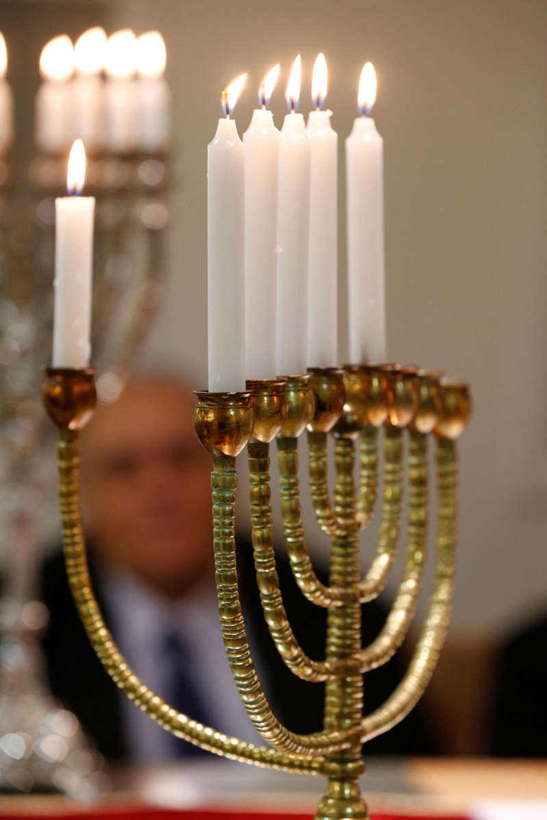 Lighting the Hanukkah candles. (Photo by: Godong/UIG via Getty Images)