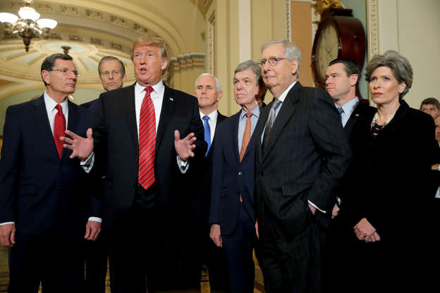 Slide 4 of 52: U.S. President Donald Trump talks to reporters as he stands with U.S. Senate Majority Leader Mitch McConnell, Vice President Mike Pence and other members of the Republican Senate leadership as the president departs after addressing a closed Senate Republican policy lunch while a partial government shutdown enters its 19th day on Capitol Hill in Washington, U.S., January 9, 2019.