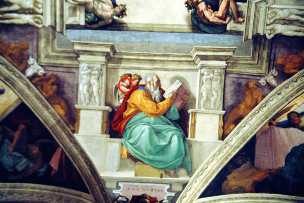 Diapositiva 6 de 26: Some of Michelangelo’s work in the Sistine Chapel might have some pretty cheeky hidden secrets. “The Prophet Zechariah,” for example, seems like a mural of the eponymous prophet reading a book while two cherubs glance over his shoulder.But, if you look closely, it appears as if one of the angels is “flipping the fig,” which is when one puts their thumb between their middle and index fingers. Basically, it’s the ye olde version of the middle finger.Rabbi Benjamin Blech of Yeshiva University told ABC News: “This perhaps is the key to understanding Michelangelo’s courage, Michelangelo’s true feelings about the Pope, and the fact that Michelangelo did not hesitate to present us with messages that might’ve been offensive.” And for more surprising Easter eggs, don’t miss these 30 Secret Messages Hidden in Popular Logos.