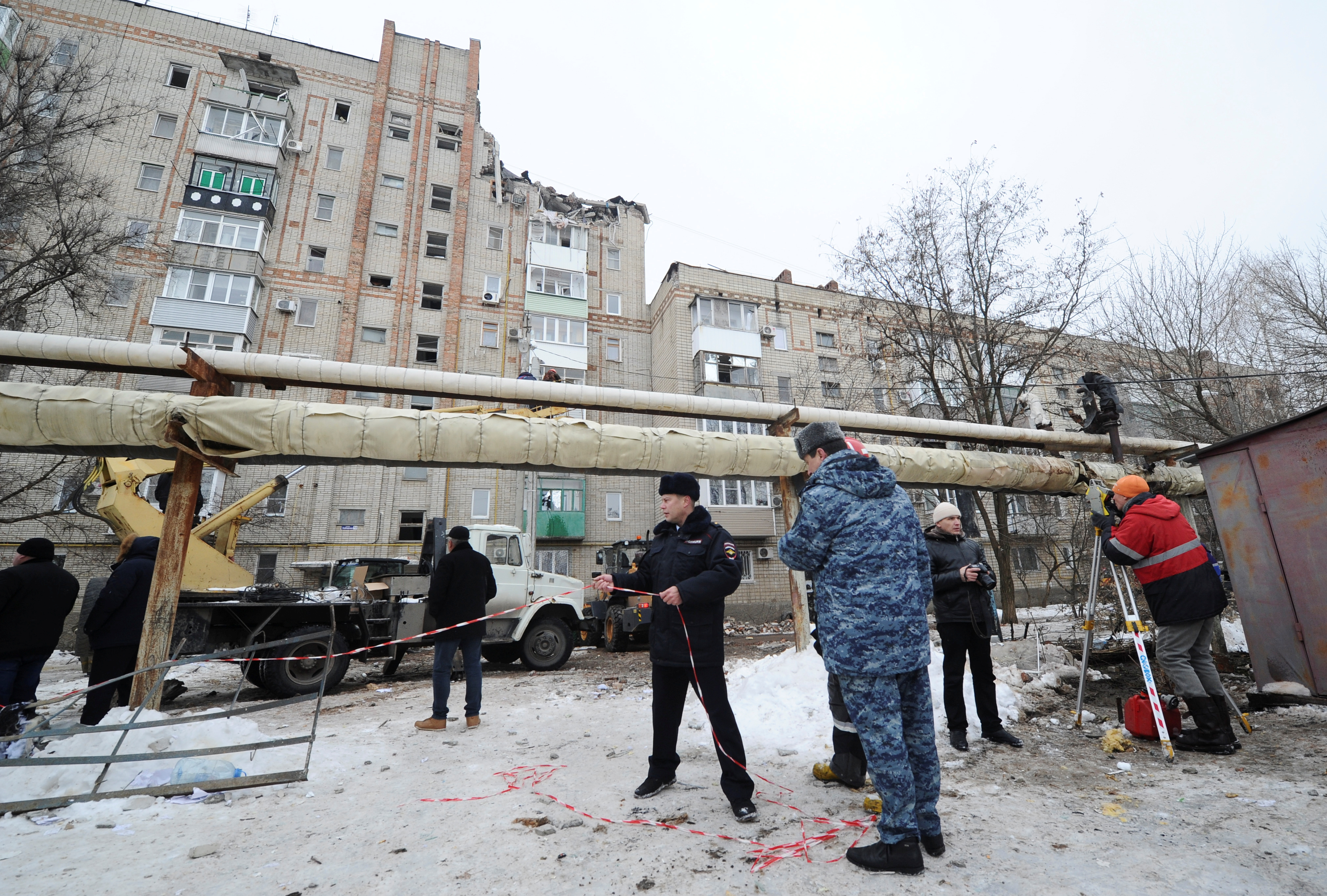 Members of emergency services gather near a damaged apartment block after an apparent gas explosion in the town of Shakhty in Rostov Region, Russia January 14, 2019.
