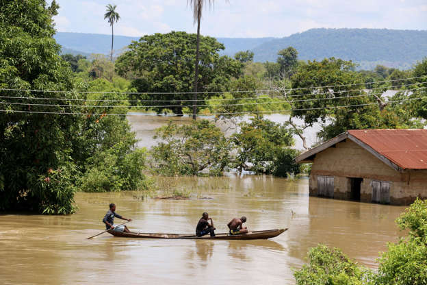 A dugout canoe is used to cross a flooded section of Lokoja, Kogi State, Nigeria on September 19, 2018.