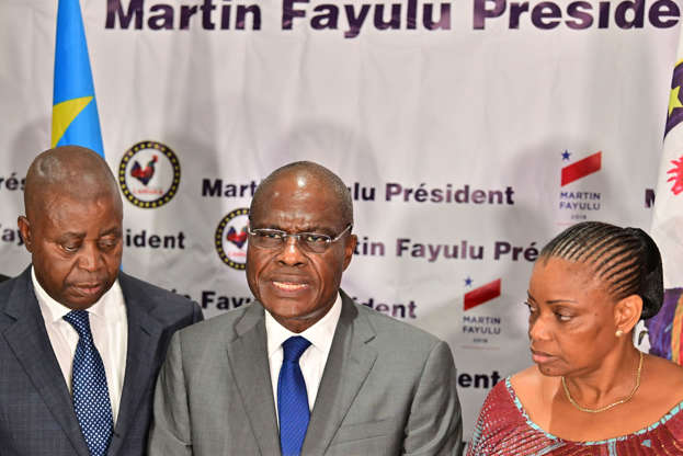 Slide 4 of 28: Opposition presidential candidate in the Democratic Republic of Congo (DRC) Martin Fayulu, flanked by his officials, speaks during a press conference on January 18, 2019 at his party headquarters in the capital Kinshasa after the African Union called to suspend the announcement of final results from presidential elections. - Runner-up Martin Fayulu, who claims he was cheated of victory, has appealed to the Constitutional Court. (Photo by TONY KARUMBA / AFP)        (Photo credit should read TONY KARUMBA/AFP/Getty Images)