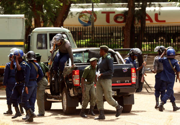 Slide 3 of 28: Police stand guard as people arrested during protests appeal in court in Harare, Zimbabwe, January 18, 2019. REUTERS/Philimon Bulawayo