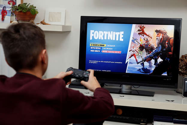 paris france december 19 in this photo illustration a gamer plays the video - fortnite gamer picture