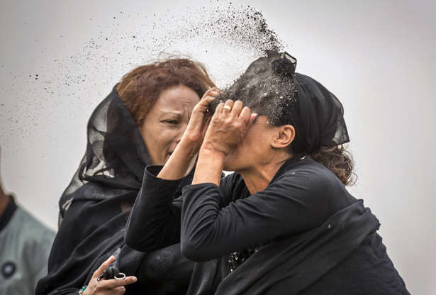 Slide 6 of 48: An Ethiopian relative of a crash victim throws dirt in her own face after realising that there is nothing physical left of her loved one, as she mourns at the scene where the Ethiopian Airlines Boeing 737 Max 8 crashed shortly after takeoff on Sunday killing all 157 on board, near Bishoftu, south-east of Addis Ababa, in Ethiopia Thursday, March 14, 2019. About 200 family members of people who died on the crashed jet stormed out of a briefing with Ethiopian Airlines officials in Addis Ababa on Thursday, complaining that the airline has not given them adequate information.