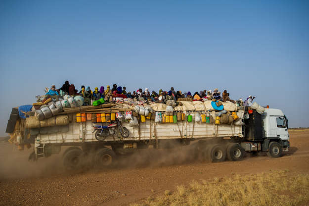 Slide 22 de 45: AGADEZ, NIGER - OCTOBER 8: A truck joins a convoy with armed military escort as it begins crossing the Sahara Desert from Niger north to Libya, overloaded with Nigerien workers and families destined for work in mines, on October 8, 2018 in Agadez, Niger. Aside from civilian convoys, National Guard patrols hunt armed Islamists in this Sahel region half the size of Texas. In a bid to stem irregular migration from Africa to Europe, the EU is spending $270 million on an 'Emergency Trust Fund' for programs in Niger, part of a security-development package that has seen the number of migrants heading north drop from 334,000 in 2016 to fewer than 50,000 in 2018. (Photo by Scott Peterson/Getty Images)