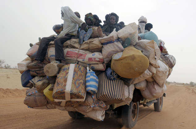 Slide 24 de 45: Photo taken May 29 on a road near Dakoro in the north of Niger shows an overloaded vehicle. In Niger, an estimated 2.7 million people will need food assistance this year while an additional 5.1 million people in the country were considered at risk of food insecurity. Thousands of pupils have abandonned their course according to UNICEFalimentaire a contraint des milliers d'eleves a abandonner les cours, selon l'Unicef.   AFP PHOTO/ ISSOUF SANOGO (Photo credit should read ISSOUF SANOGO/AFP/Getty Images)