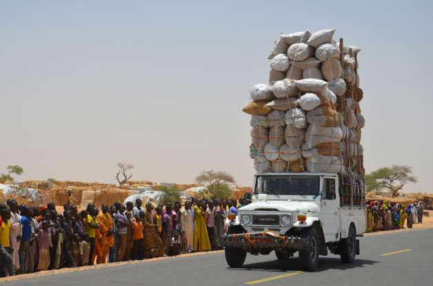Slide 27 de 45: TOPSHOT - An overloaded car travels through the Assaga refugee camp in Diffa on May 17, 2016, close to the Niger-Nigeria border.
Chief of Humanitarian Operations of the UN, Stephen O'Brien, vowed on May 17 to raise funds at the next World Humanitarian Summit for 'significant' help to the more than 240,000 refugees displaced by Boko Haram in camps in south-east Niger. / AFP / BOUREIMA HAMA        (Photo credit should read BOUREIMA HAMA/AFP/Getty Images)