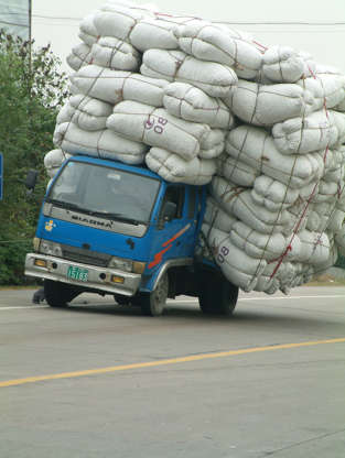 Slide 36 de 45: An overloaded truck looks ready to topple over