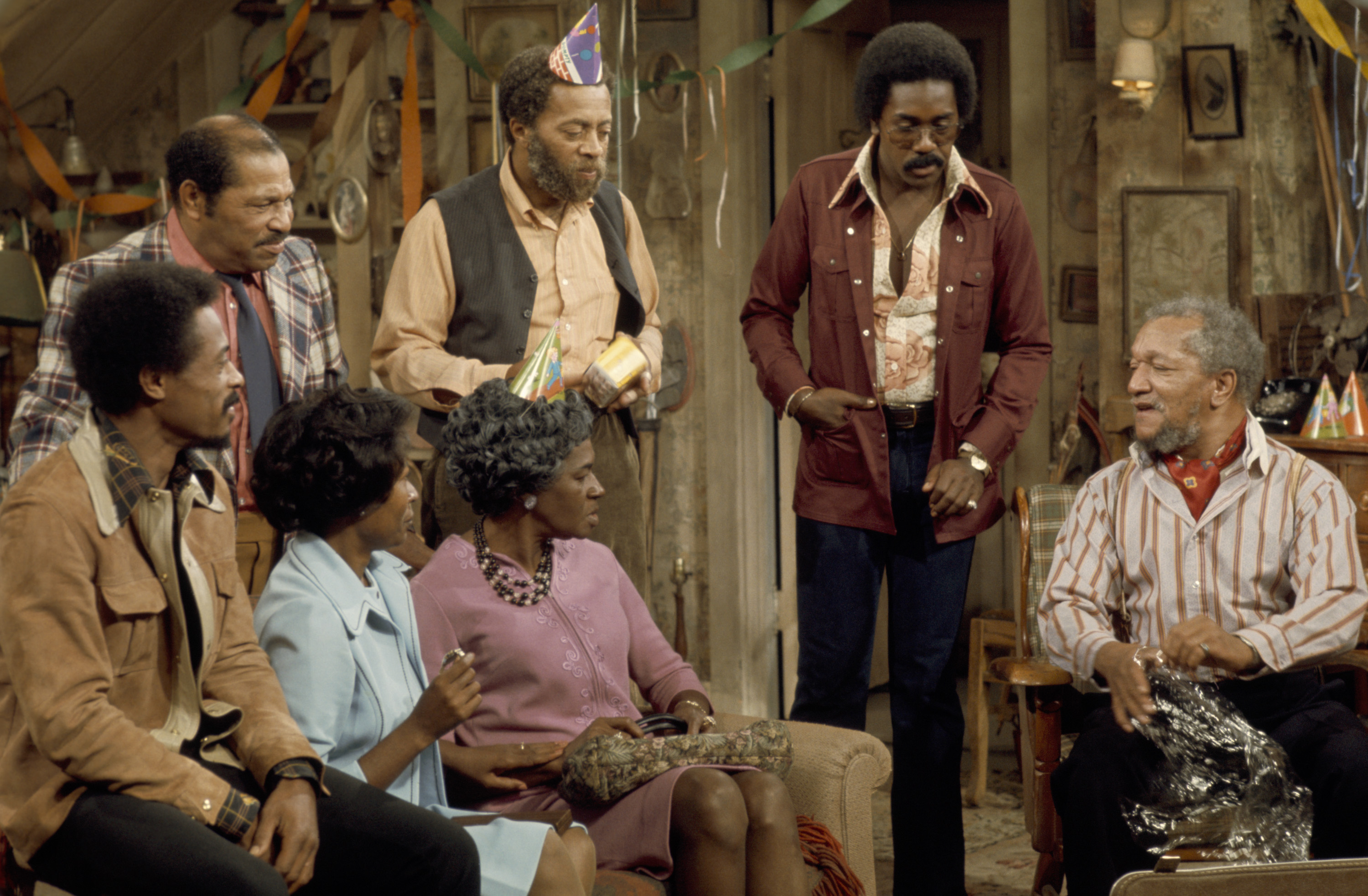 SANFORD AND SON -- 'The Surprise Party' Episode 1 -- Aired 9/13/74 -- Pictured: (back row l-r) Don Bexley as Bubba Bexley, Whitman Mayo as Grady Wilson, Demond Wilson as Lamont Sanford, Redd Foxx as Fred G. Sanford (front row l-r) Nathaniel Taylor as Rollo Larson, Lynn Hamilton as Donna Harris, LaWanda Page as Aunt Esther (Photo by NBC/NBCU Photo Bank via Getty Images)